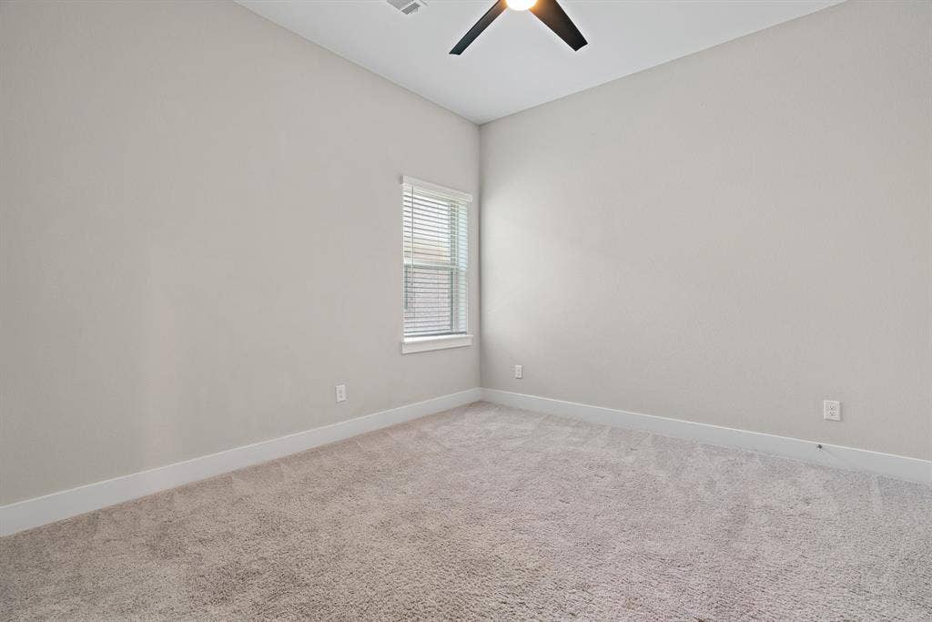 1821 Stonewall Road, Argyle, TX 76226 Carpeted room featuring a ceiling fan, a window with blinds, light gray walls, and white baseboards