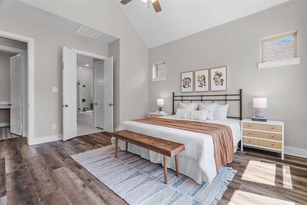 1821 Stonewall Road, Argyle, TX 76226 Bedroom featuring vaulted ceilings, wood-finish flooring, two upper windows, and a ceiling fan