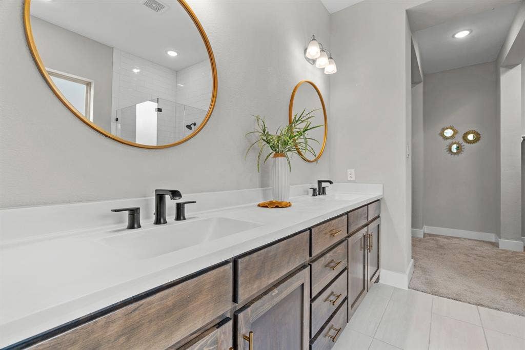 1821 Stonewall Road, Argyle, TX 76226 Dual vanity with white countertops, undermount sinks, and matte black fixtures