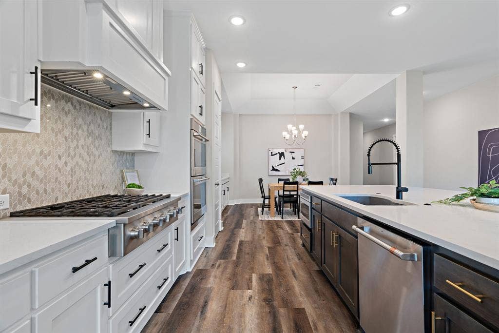 1821 Stonewall Road, Argyle, TX 76226 Gourmet kitchen featuring a commercial-style range, light-toned backsplash, and white cabinetry