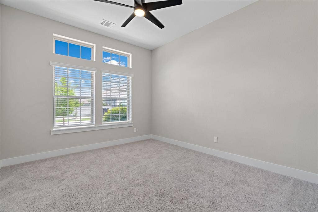1821 Stonewall Road, Argyle, TX 76226 Neutral-toned room featuring a large window array with horizontal blinds and clerestory windows