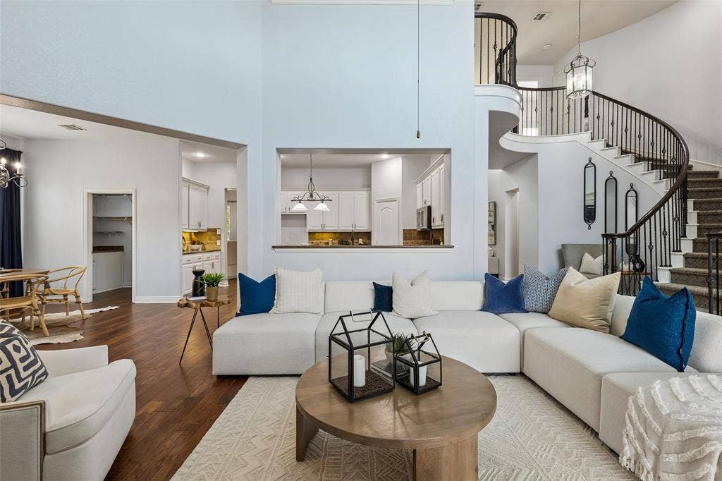 7975 Bishop Drive, Frisco, TX 75036 Soaring 2 story vaulted living room with tons of natural light, engineered hardwood floors, and gas fireplace.