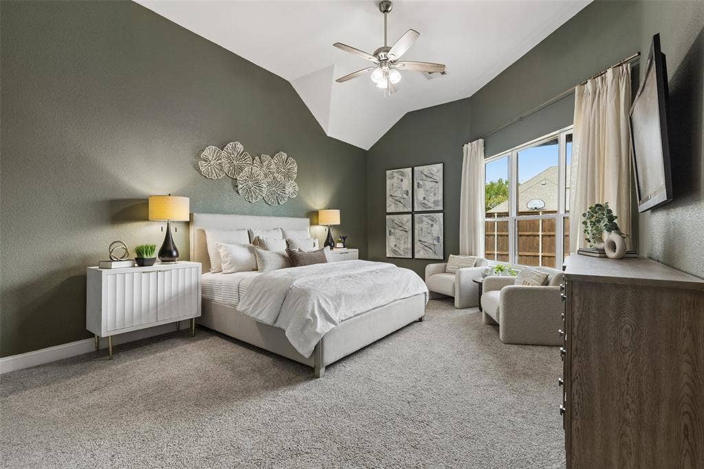 7975 Bishop Drive, Frisco, TX 75036 Spacious main level primary bedroom with vaulted ceilings, room for a sitting area, en-suite bathroom, and walk in closet.
