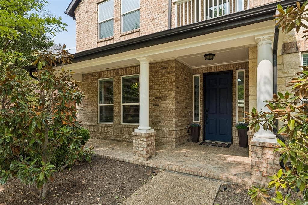 7975 Bishop Drive, Frisco, TX 75036 Front entry of property featuring a front porch.
