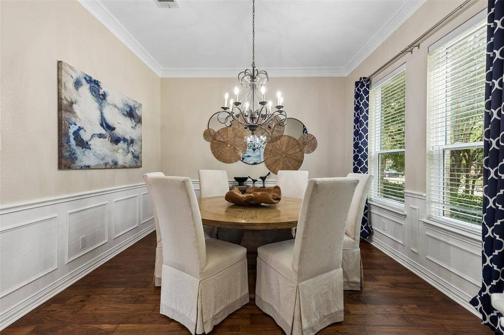7975 Bishop Drive, Frisco, TX 75036 Formal dining space featuring crown molding, wainscoting, and engineered hardwood flooring.