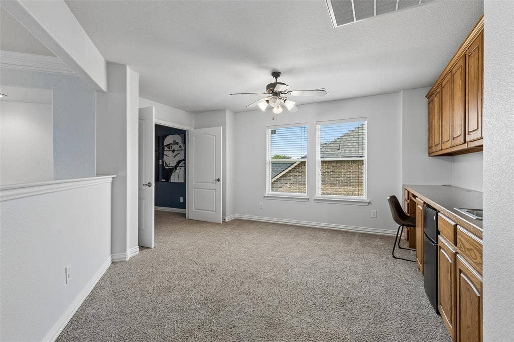 7975 Bishop Drive, Frisco, TX 75036 Spacious game room with 2 entertainment areas. This one featuring a large planning desk and wet bar.