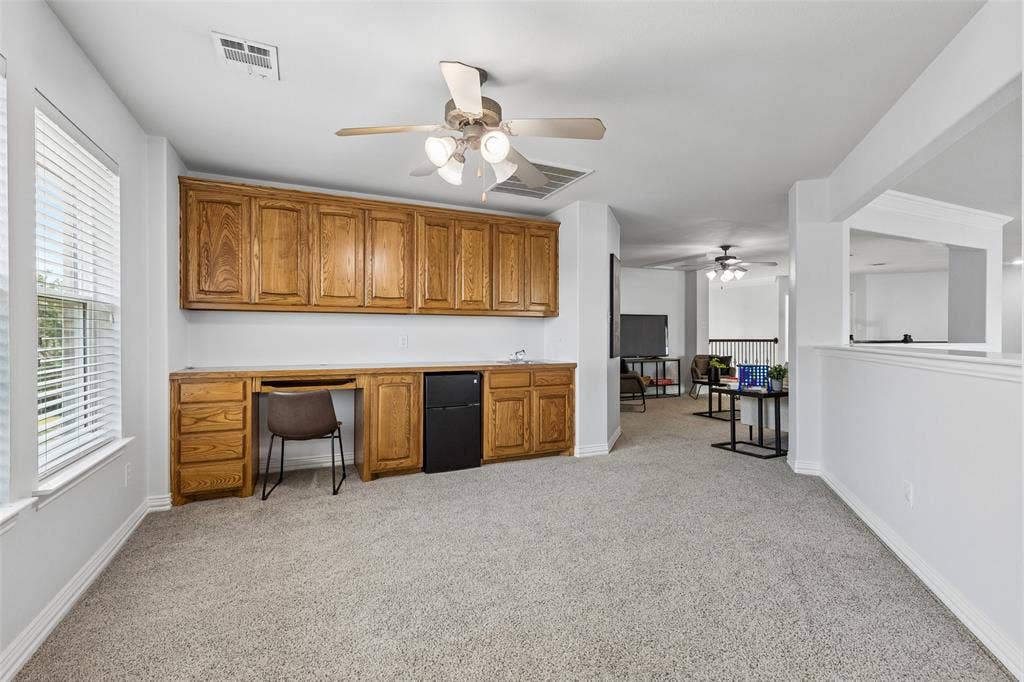 7975 Bishop Drive, Frisco, TX 75036 Spacious game room with 2 entertainment areas. This one featuring a large planning desk and wet bar.