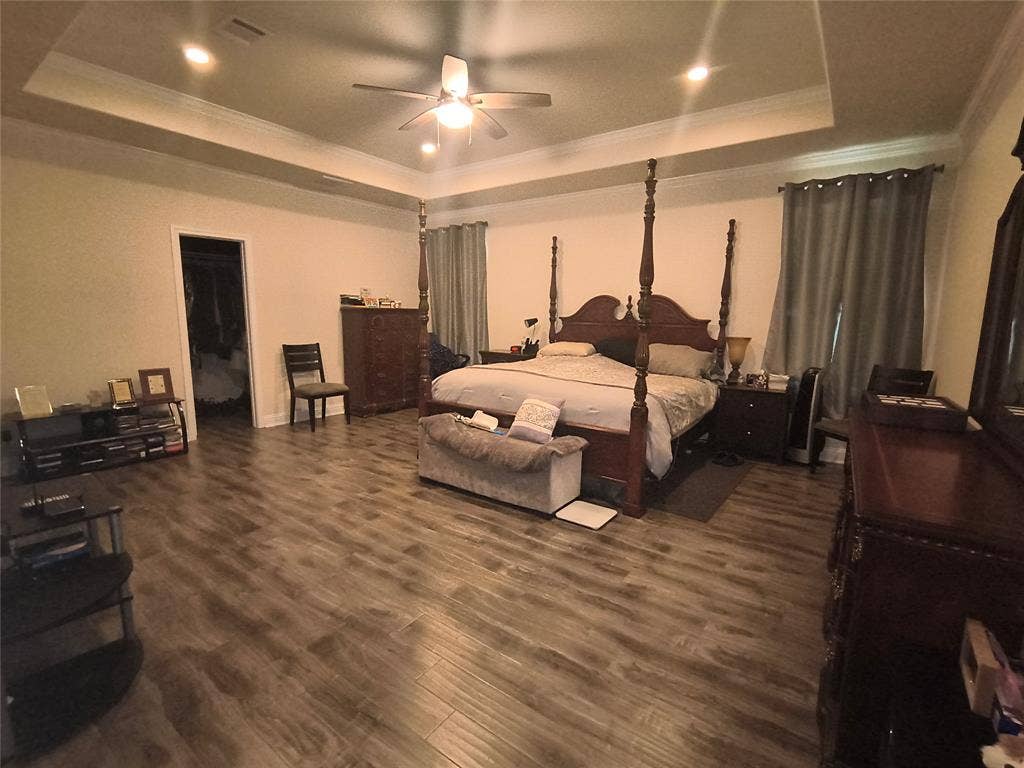 3027 Ames Road, Lancaster, TX 75134 Spacious bedroom featuring wood-finish flooring and a tray ceiling with recessed lighting