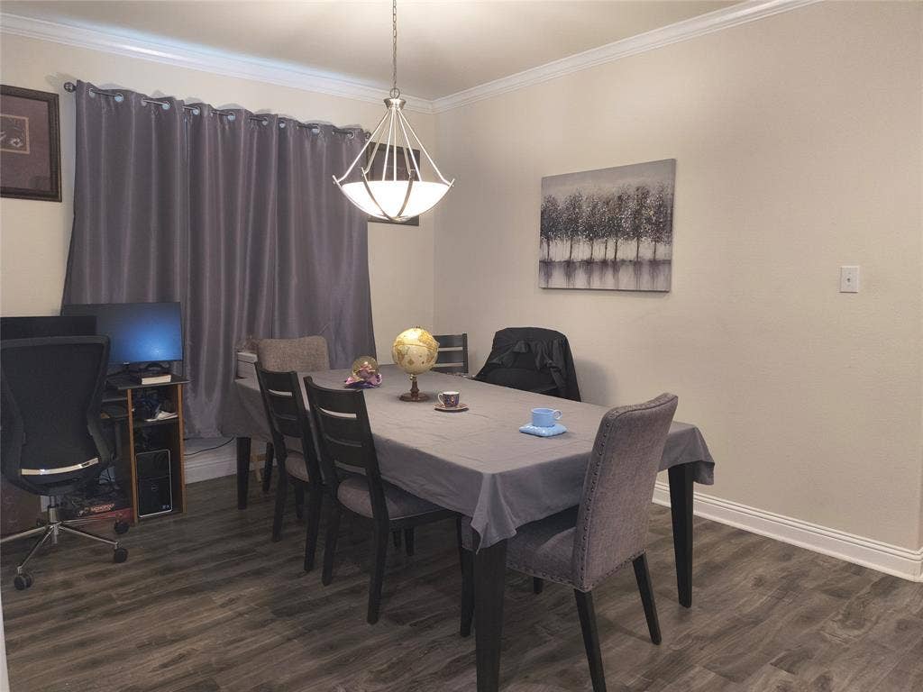 3027 Ames Road, Lancaster, TX 75134 Spacious room featuring wood-finish flooring, crown molding, and baseboards