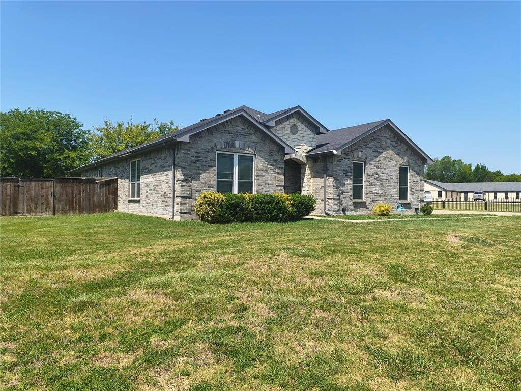 3027 Ames Road, Lancaster, TX 75134 Gray brick exterior with dark shingle roofing