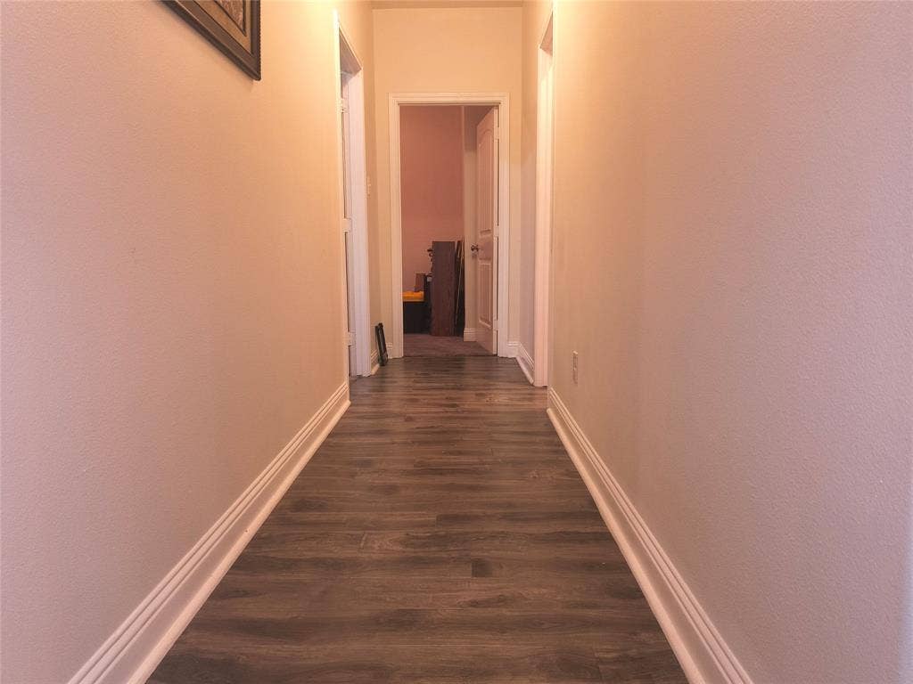 3027 Ames Road, Lancaster, TX 75134 Hallway featuring wood-finish flooring and light-toned walls with white baseboards