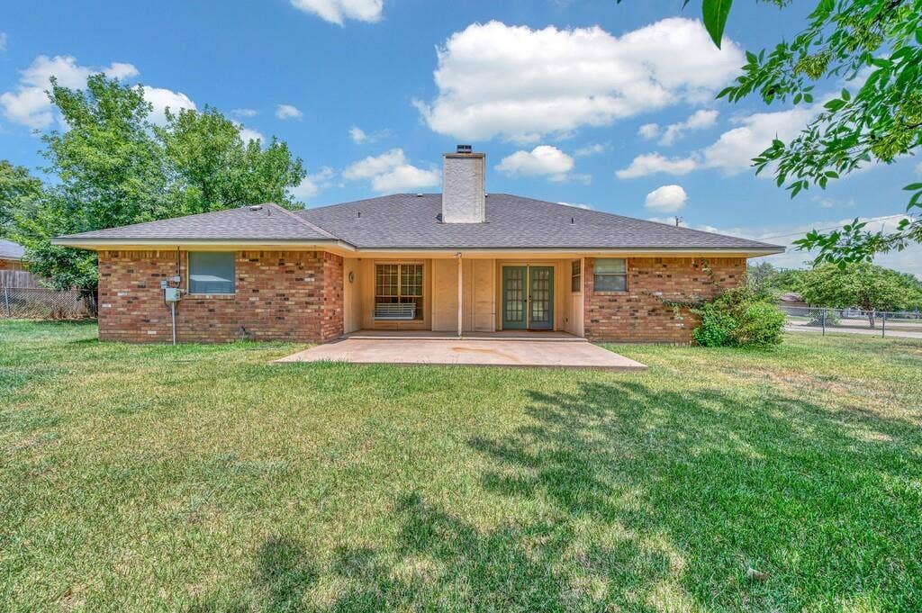 600 Lyndon Drive, Woodway, TX 76712 Expansive backyard featuring a large concrete patio, brick exterior, and dual French doors