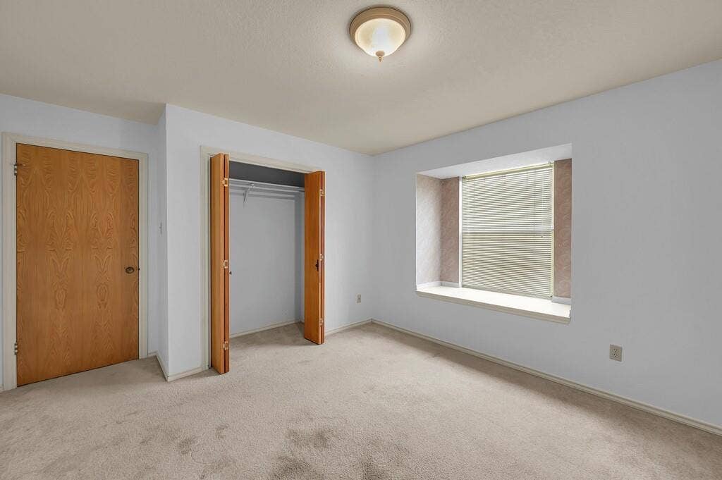 600 Lyndon Drive, Woodway, TX 76712 Recessed window with a sill, neutral carpet, bi-fold closet doors, and wood-finish interior doors