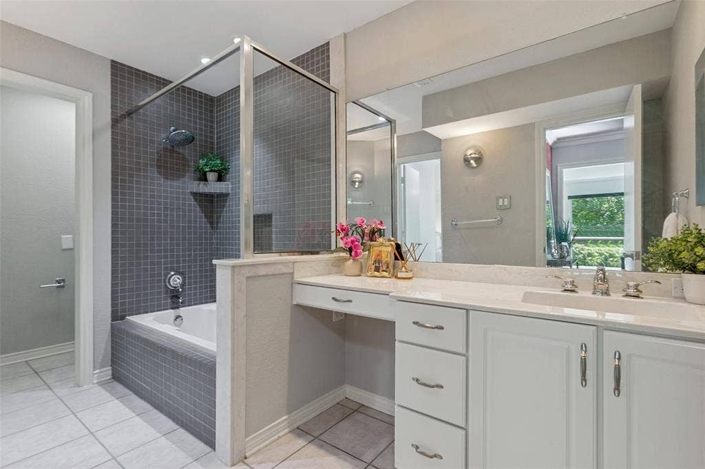 6362 Southpoint Drive, Dallas, TX 75248 White cabinetry with chrome hardware, separate shower, toilet, and a large vanity mirror