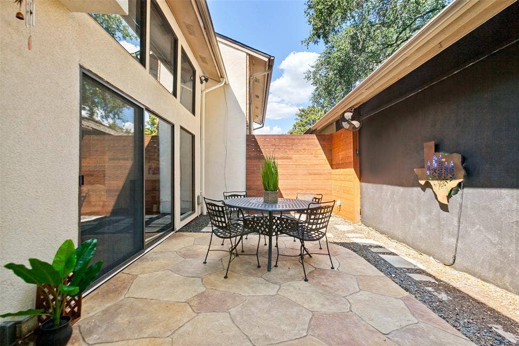 6362 Southpoint Drive, Dallas, TX 75248 Stamped concrete patio with a privacy fence, stucco exterior, and sliding glass doors