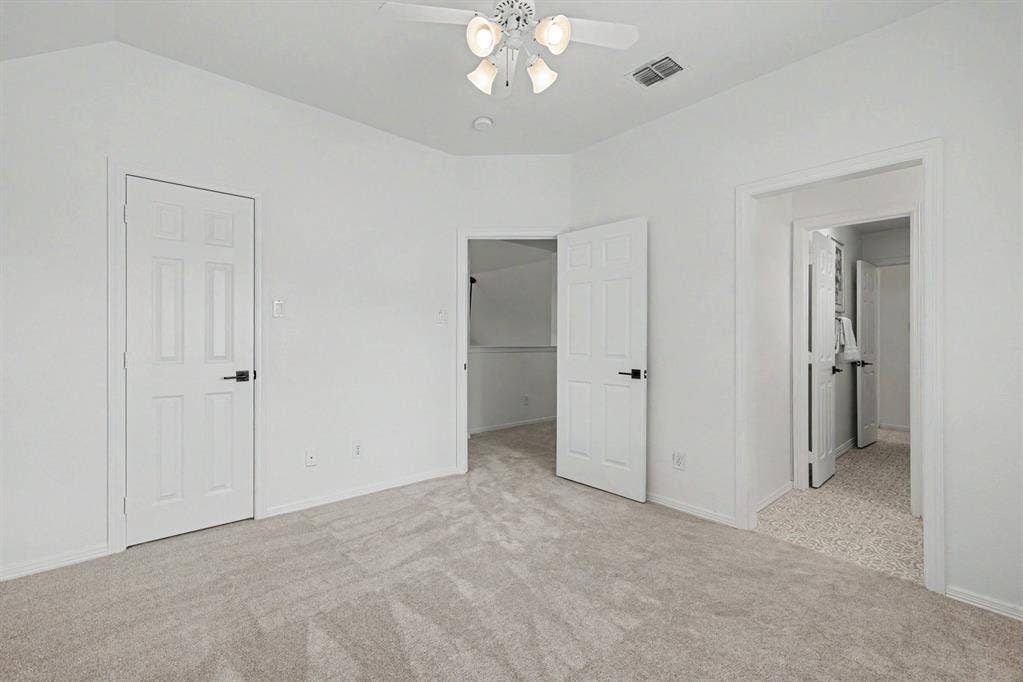 7904 Alderwood Place, Plano, TX 75025 Interior room featuring light-toned carpeting, white walls, and a ceiling fan with integrated lighting