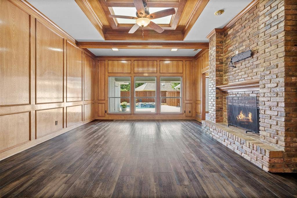 2112 Evergreen Drive, Plano, TX 75075 Oversized living room with built ins and a fireplace looking out to the pool