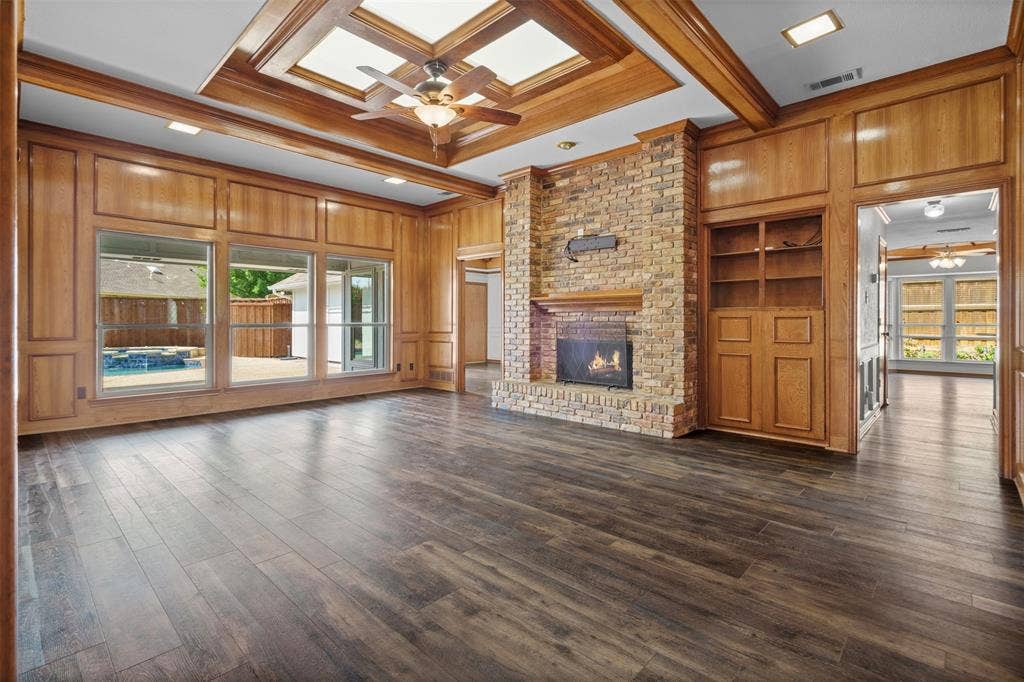 2112 Evergreen Drive, Plano, TX 75075 Oversized living room with built ins and a fireplace looking out to the pool