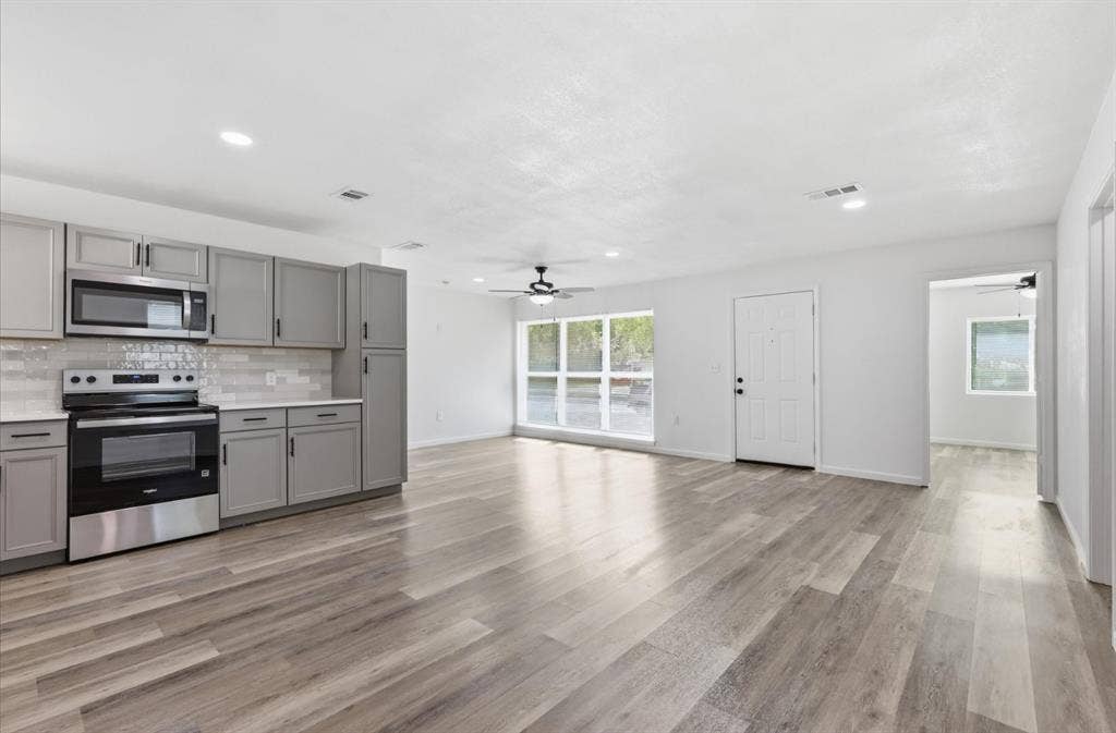 810 N Carrier Parkway, Grand Prairie, TX 75050 Open concept living area featuring wood-finish flooring, recessed lighting, and a ceiling fan