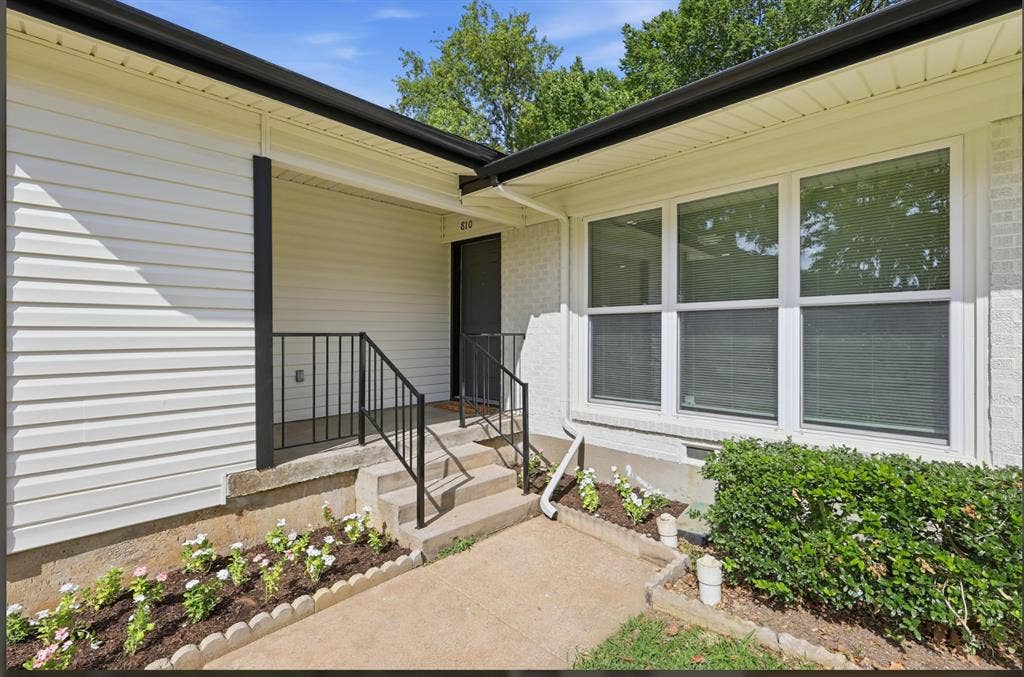 810 N Carrier Parkway, Grand Prairie, TX 75050 Exterior facade featuring white siding and white painted brickwork