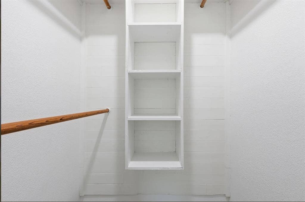 810 N Carrier Parkway, Grand Prairie, TX 75050 Walk-in closet featuring built-in shelving, dual hanging rods, and white painted walls