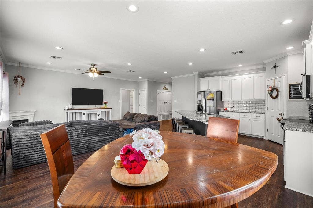 215 Greenbriar Street, Robinson, TX 76706 Open-concept living space featuring wood-finish flooring, recessed lighting, and crown molding