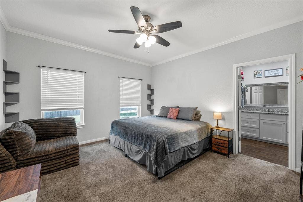 215 Greenbriar Street, Robinson, TX 76706 Spacious room featuring carpet flooring, crown molding, and two windows with blinds