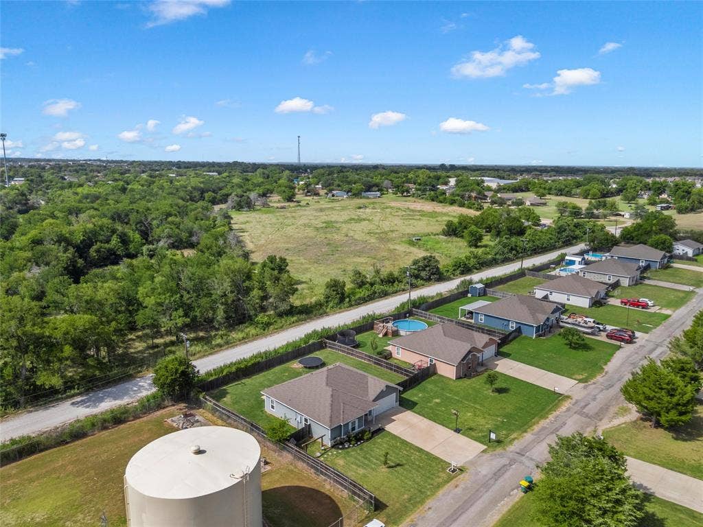 215 Greenbriar Street, Robinson, TX 76706 Aerial perspective showcasing a residential community with individual properties, each featuring a private yard and paved driveway