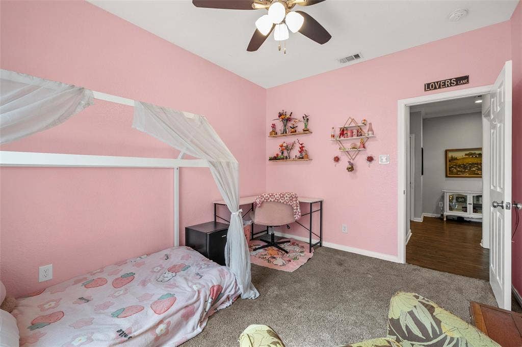 215 Greenbriar Street, Robinson, TX 76706 Carpeted room featuring a ceiling fan with integrated lighting, a standard door frame, and angled walls