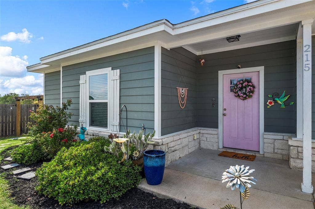 215 Greenbriar Street, Robinson, TX 76706 Front entry featuring a lavender door, gray siding, and a stone facade