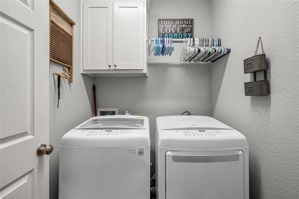 215 Greenbriar Street, Robinson, TX 76706 Laundry area with overhead white cabinetry, a built-in hanging rod, and textured walls