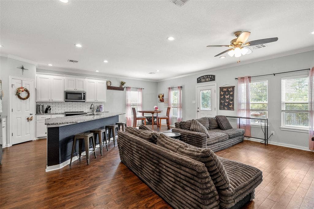 215 Greenbriar Street, Robinson, TX 76706 Open-concept living space featuring wood-finish flooring throughout