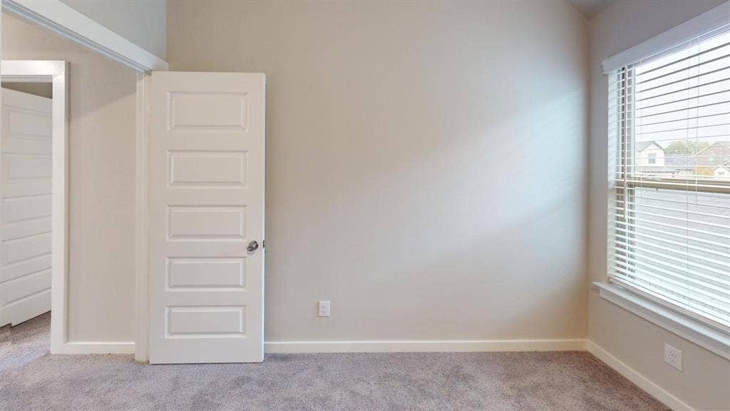 1323 Great Sand Dune Street, Royse City, TX 75189 Bedroom featuring neutral carpeting, light-toned walls, and a multi-paneled door