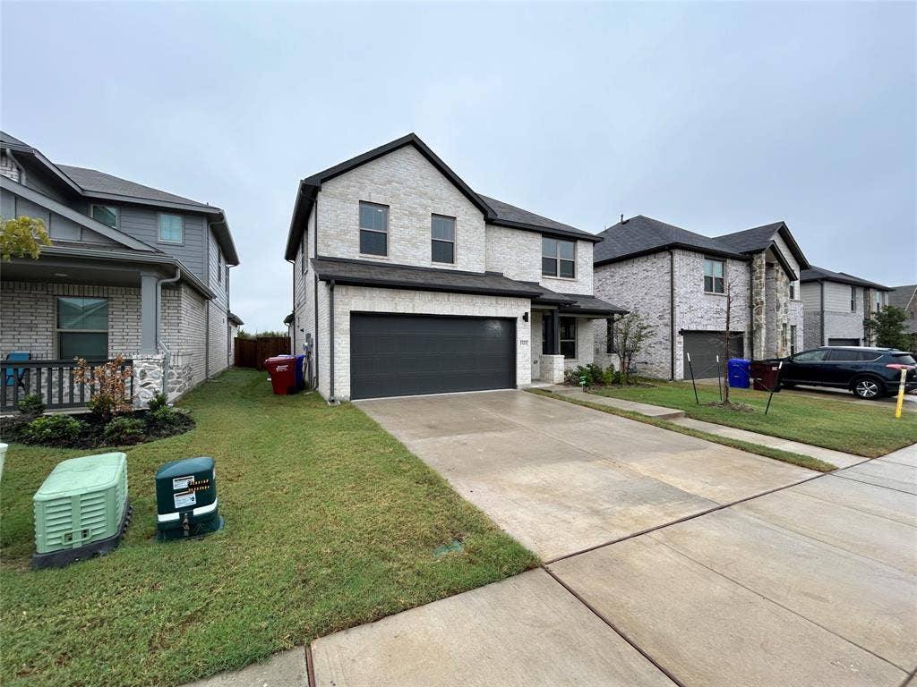 1323 Great Sand Dune Street, Royse City, TX 75189 Contemporary two-story residence featuring light-colored brick and dark trim