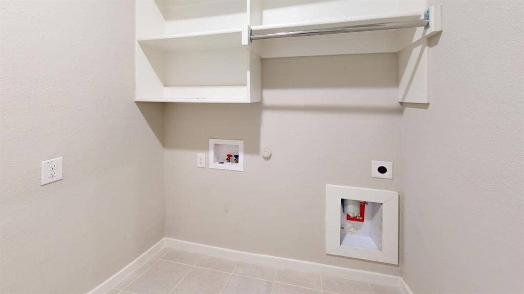 1323 Great Sand Dune Street, Royse City, TX 75189 Utility space featuring tile flooring, white wall-mounted cabinetry, a clothes hanging rod, and dedicated appliance hookups