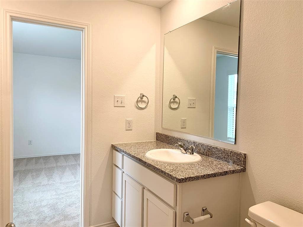 7212 Gray Wolf Lane, McKinney, TX 75071 Bathroom featuring toilet and large vanity
