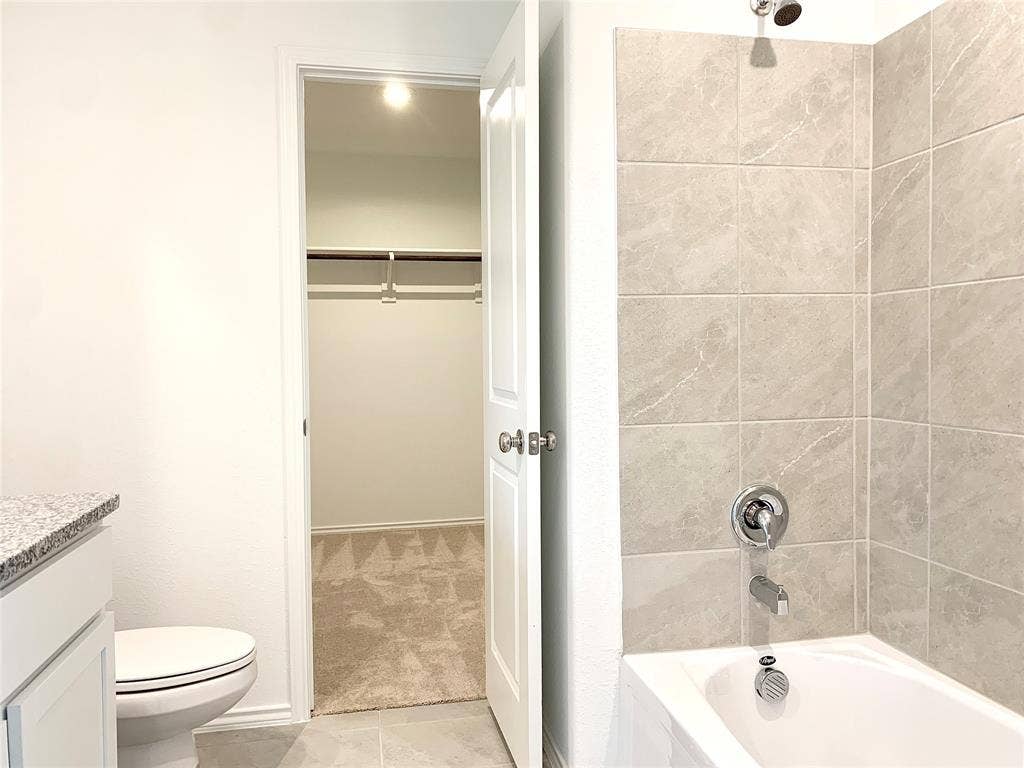 7212 Gray Wolf Lane, McKinney, TX 75071 Full bathroom featuring tile flooring, vanity, tiled shower / bath combo, and toilet