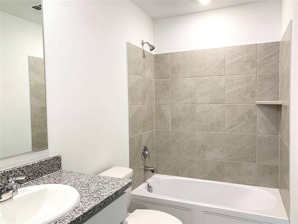 7212 Gray Wolf Lane, McKinney, TX 75071 Full bathroom featuring vanity, tiled shower