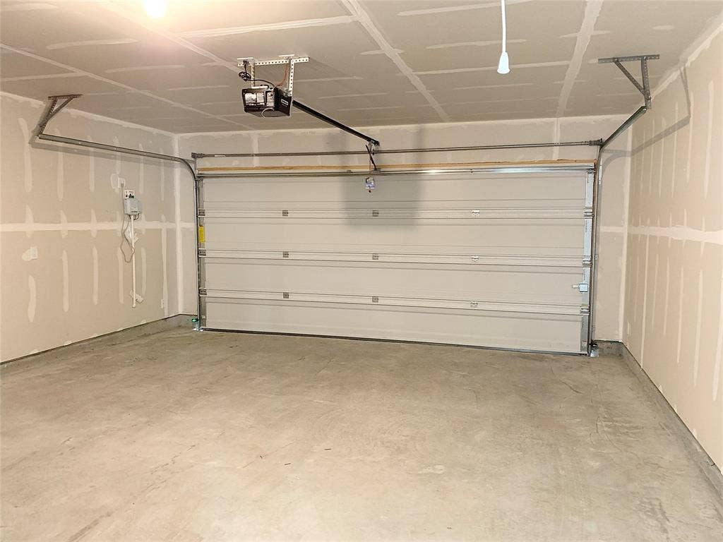 7212 Gray Wolf Lane, McKinney, TX 75071 Garage featuring a garage door opener