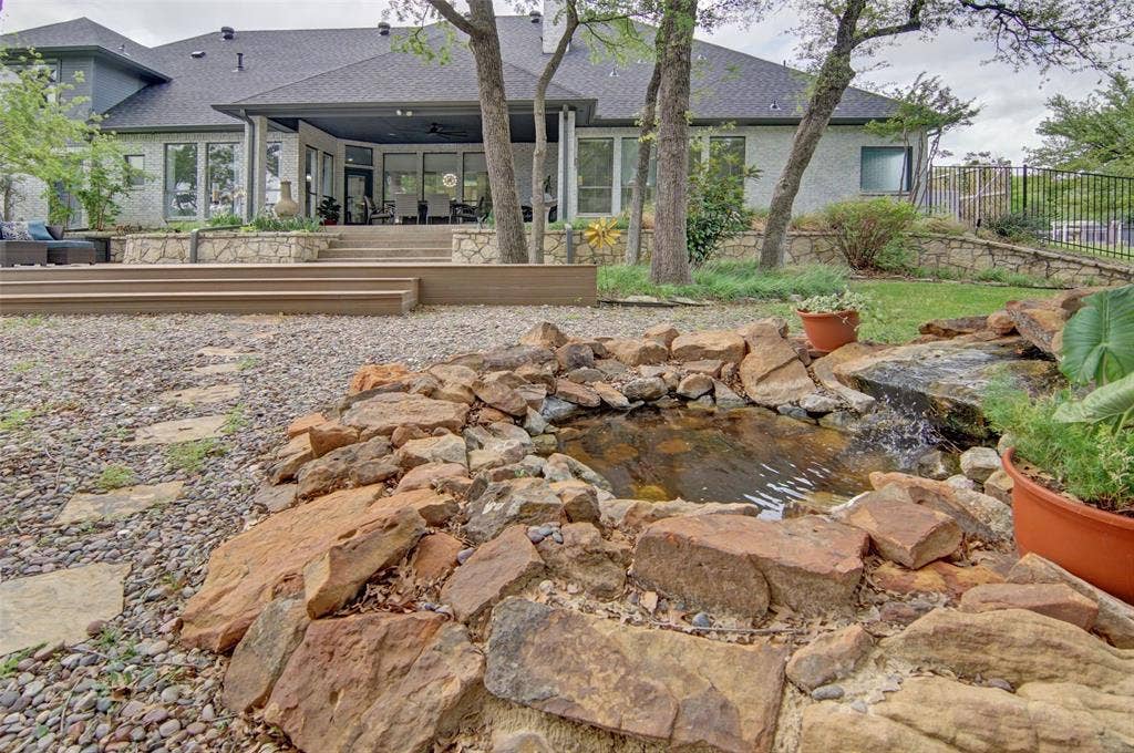 1202 Forest Park Drive, Weatherford, TX 76087 Beautifully landscaped backyard with peaceful, trickling water feature.