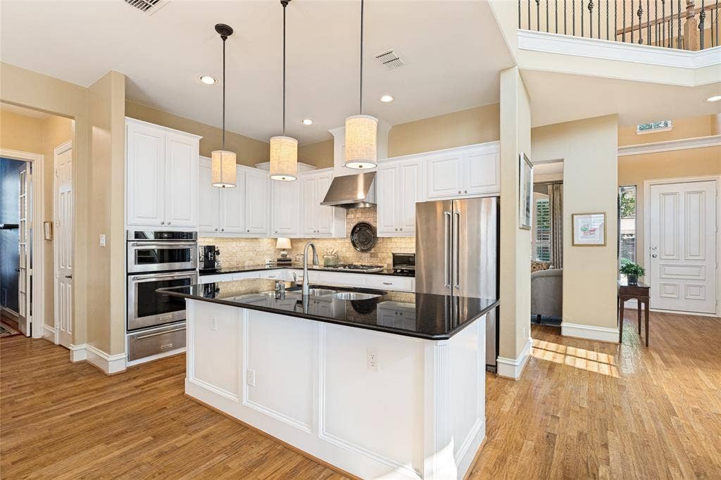 1021 Bandelier Drive, Allen, TX 75013 Warm under cabinet lighting in kitchen and pendant lights over island