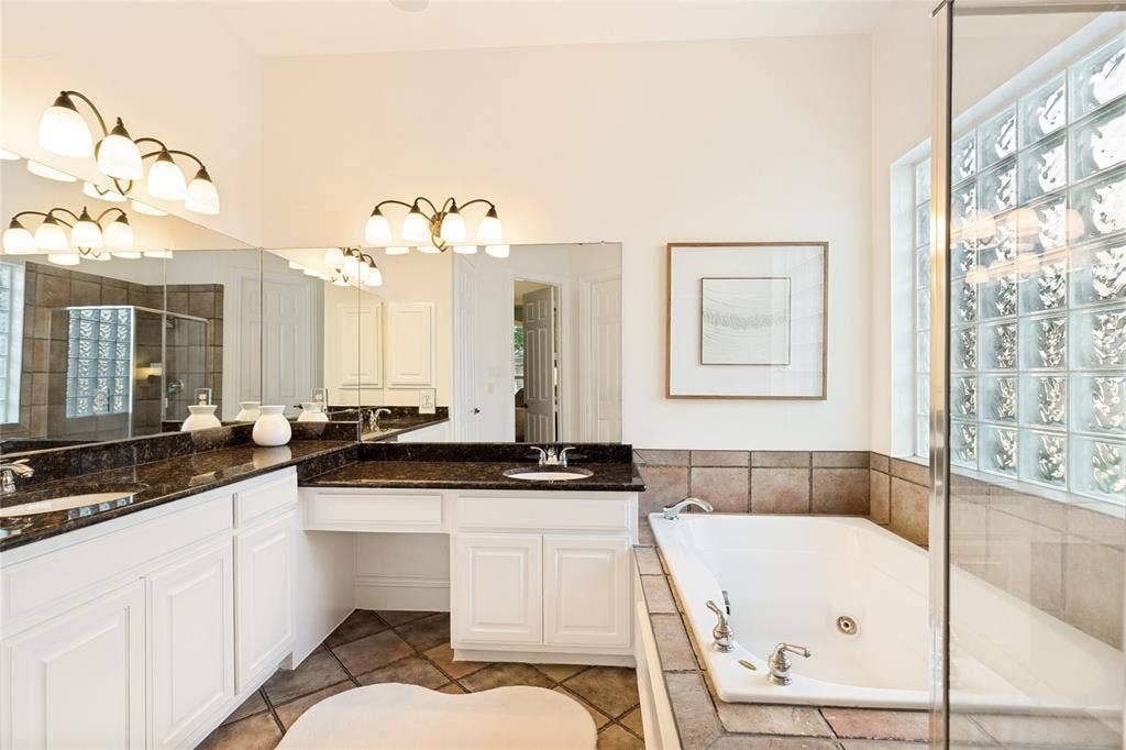 1021 Bandelier Drive, Allen, TX 75013 Spacious primary bath with separate hi-low sinks, vanity, jetted tub, block windows for light and separate shower