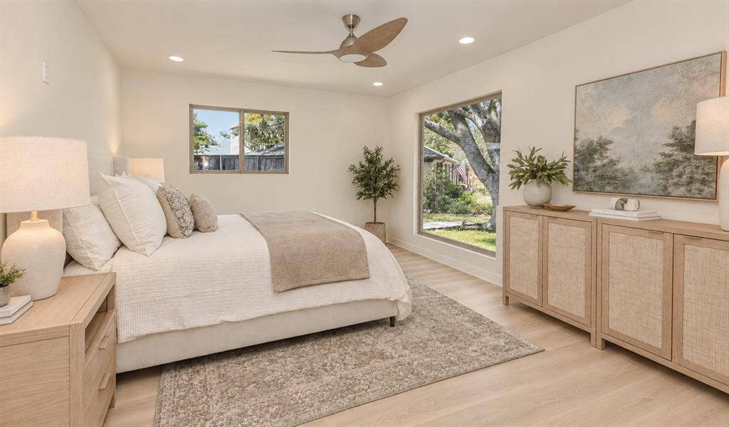 Light wood-finish flooring, recessed lighting, and a ceiling fan with integrated lighting