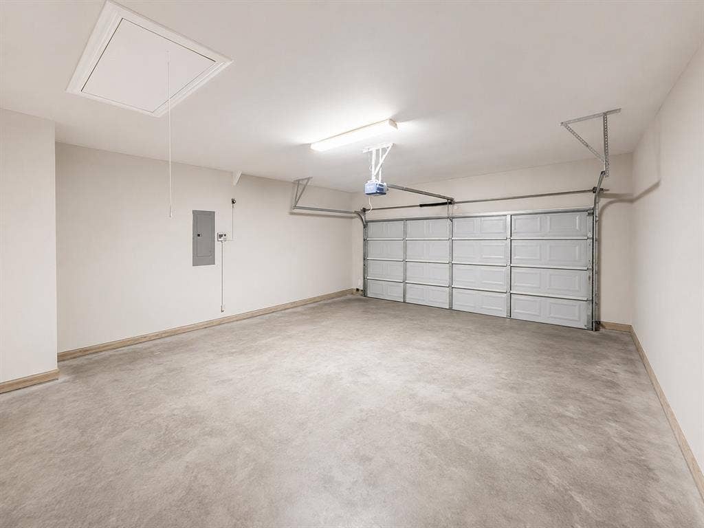 1709 Belton Drive, Prosper, TX 75078 Spacious two-car garage featuring a concrete floor, automatic garage door opener, and overhead fluorescent lighting