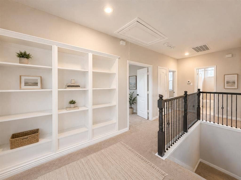 1709 Belton Drive, Prosper, TX 75078 Built-in white shelving unit with crown molding, recessed lighting, carpeted flooring, and dark wood newel post with black metal balusters
