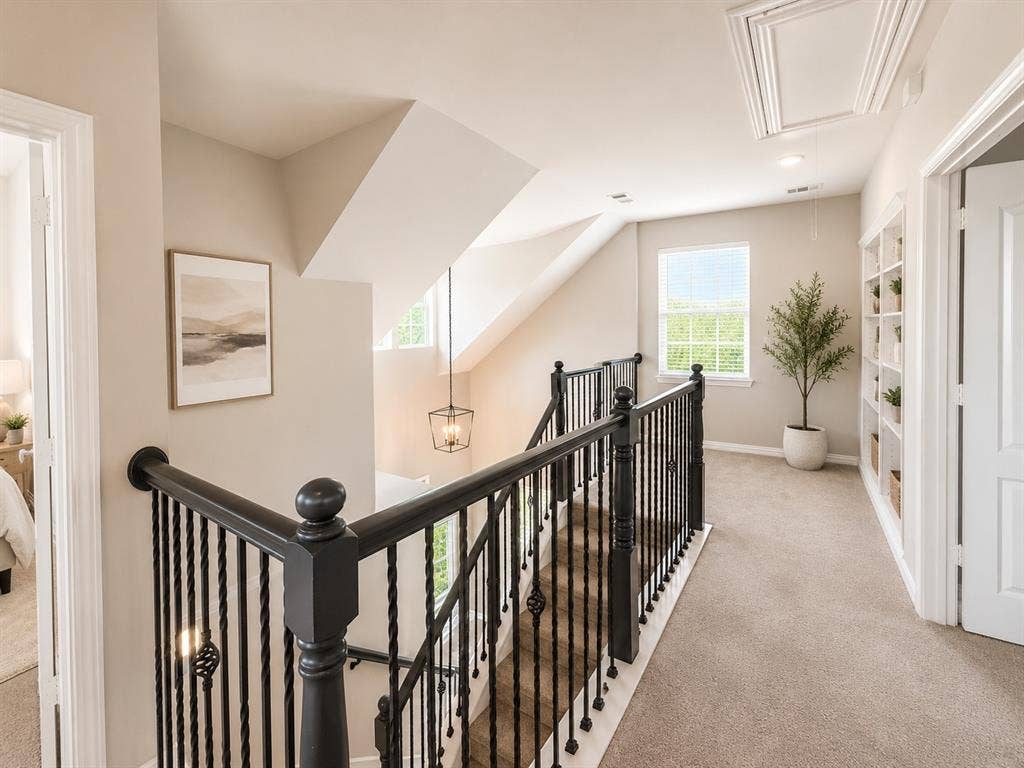 1709 Belton Drive, Prosper, TX 75078 Staircase featuring dark wood handrails and wrought iron balusters
