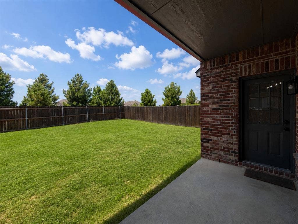 1709 Belton Drive, Prosper, TX 75078 Expansive green lawn surrounded by a wooden privacy fence