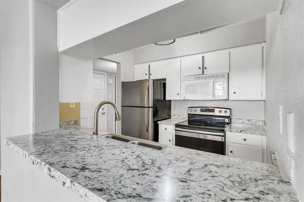 5881 Preston View Boulevard, Dallas, TX 75240 Ample cabinet space, stainless steel appliances