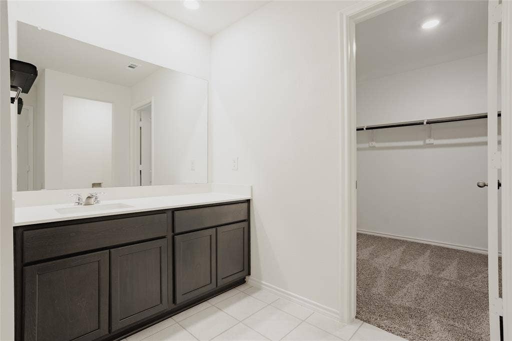 2904 Goodrich Street, Royse City, TX 75189 Bathroom vanity with a white countertop and dark wood-finish cabinetry