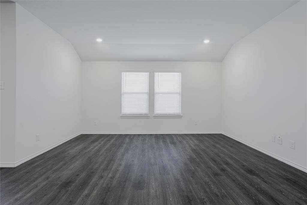2904 Goodrich Street, Royse City, TX 75189 Spacious room featuring dark wood-finish flooring, white walls, and a window with blinds